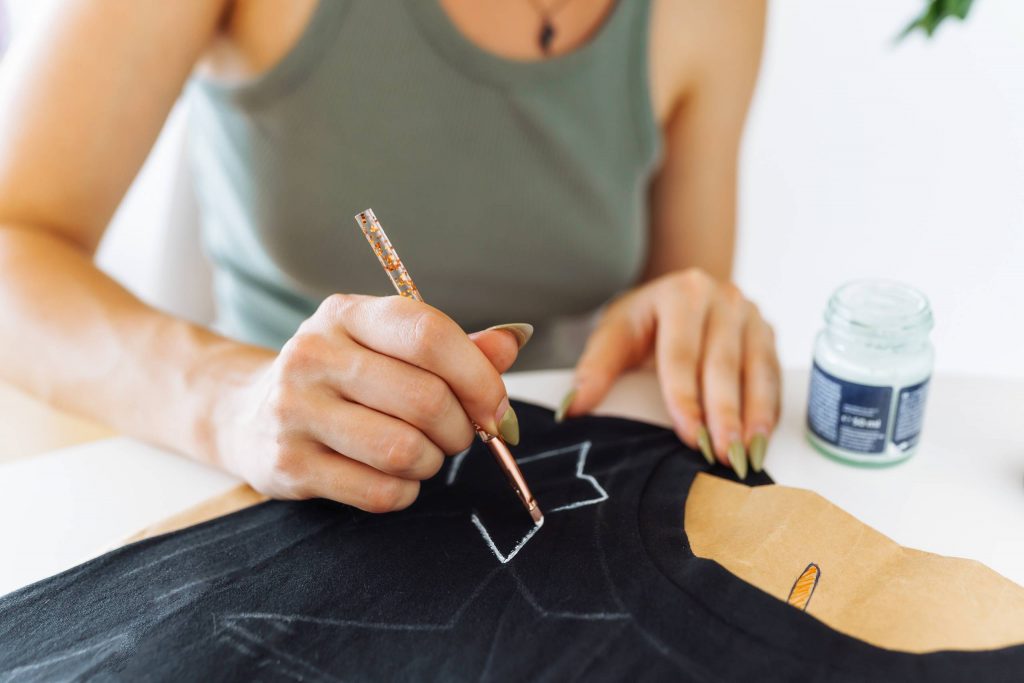 young woman draws picture on clothes with paints 2026 01 08 06 39 42 utc